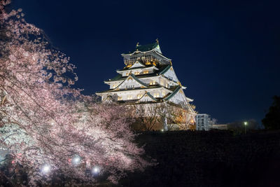 Low angle view of illuminated building against sky at night