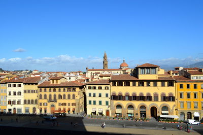 Buildings in city against blue sky