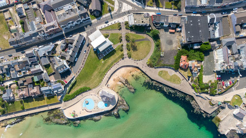 High angle view of swimming pool by buildings in city