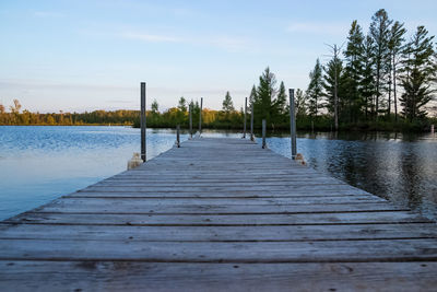 Surface level of pier on lake against sky