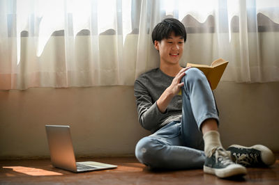 Young woman using laptop at home