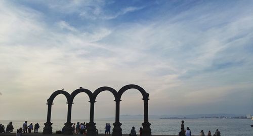 People at beach against sky