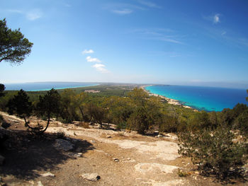 View of calm beach against blue sky