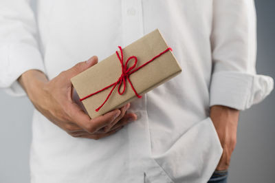 Midsection of man holding paper box