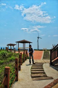 Man standing on walkway at miaoli cape of good hope