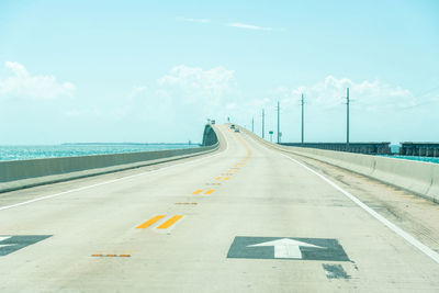 Road by sea against sky