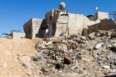 Damaged building in syria against clear blue sky