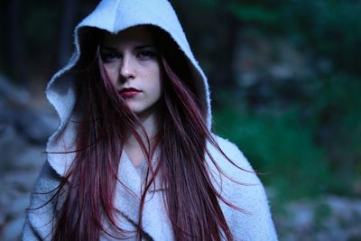 Portrait of beautiful young woman in hooded shirt