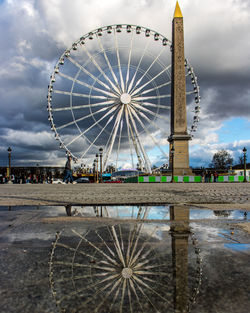 Ferris wheel against cloudy sky