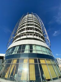 Low angle view of modern building against blue sky