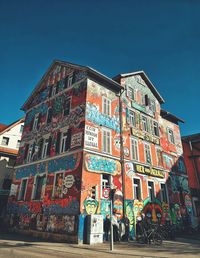 Low angle view of multi colored building against sky