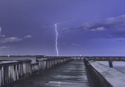 View of bridge over water at night