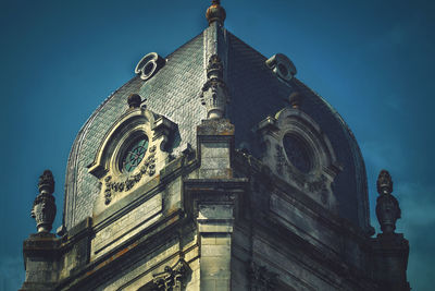 Low angle view of ornate building against blue sky