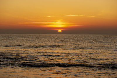 Scenic view of sea against romantic sky at sunset