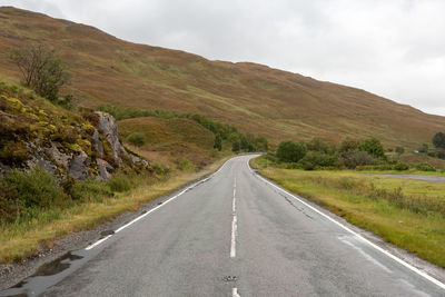 Wet road with a landscape view in the scotthish highlands