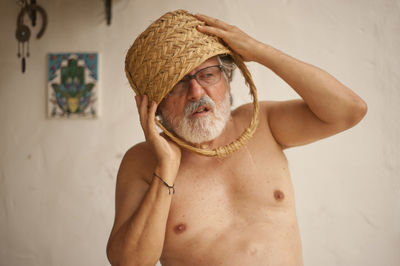 Portrait of shirtless man wearing hat