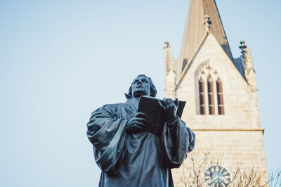 Low angle view of statue against temple