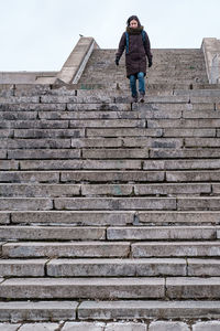 Low angle view of man standing on staircase