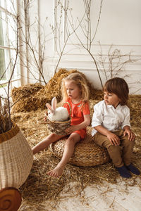 Easter kids playing with rabbits and ducks