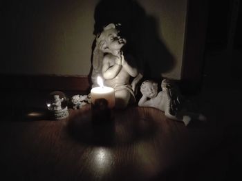 Close-up of buddha statue on table at home