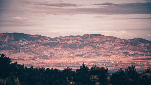 Scenic view of silhouette mountains against sky at sunset