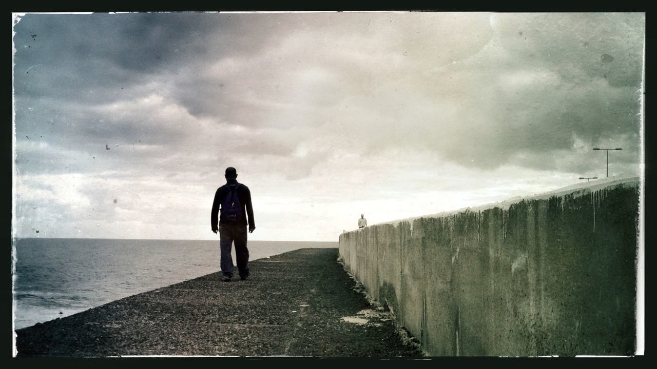 transfer print, auto post production filter, sky, full length, sea, walking, cloud - sky, rear view, men, beach, lifestyles, water, horizon over water, leisure activity, cloud, standing, cloudy, person