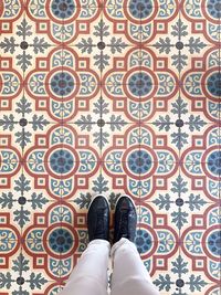 Low section of woman standing on tiled floor
