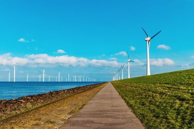 Windmill on field against sky  netherlands flevoland wind mill turbines 
