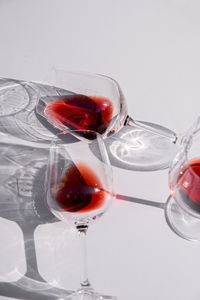 Close-up of wineglass on table against white background