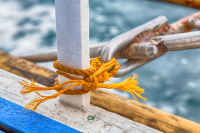Close-up of rope tied on metal railing