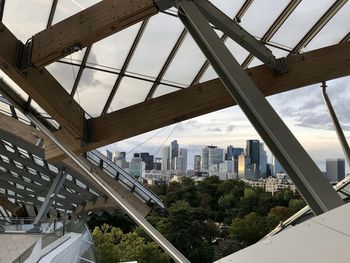 Bridge by buildings in city against sky