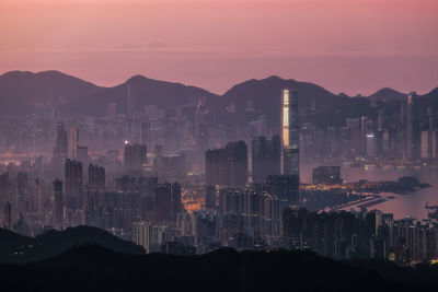 Illuminated cityscape against sky at night