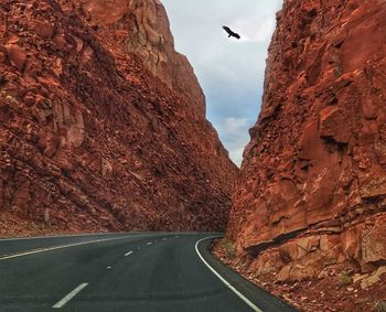 Road by mountain against sky