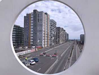 Panoramic view of city street and buildings against sky