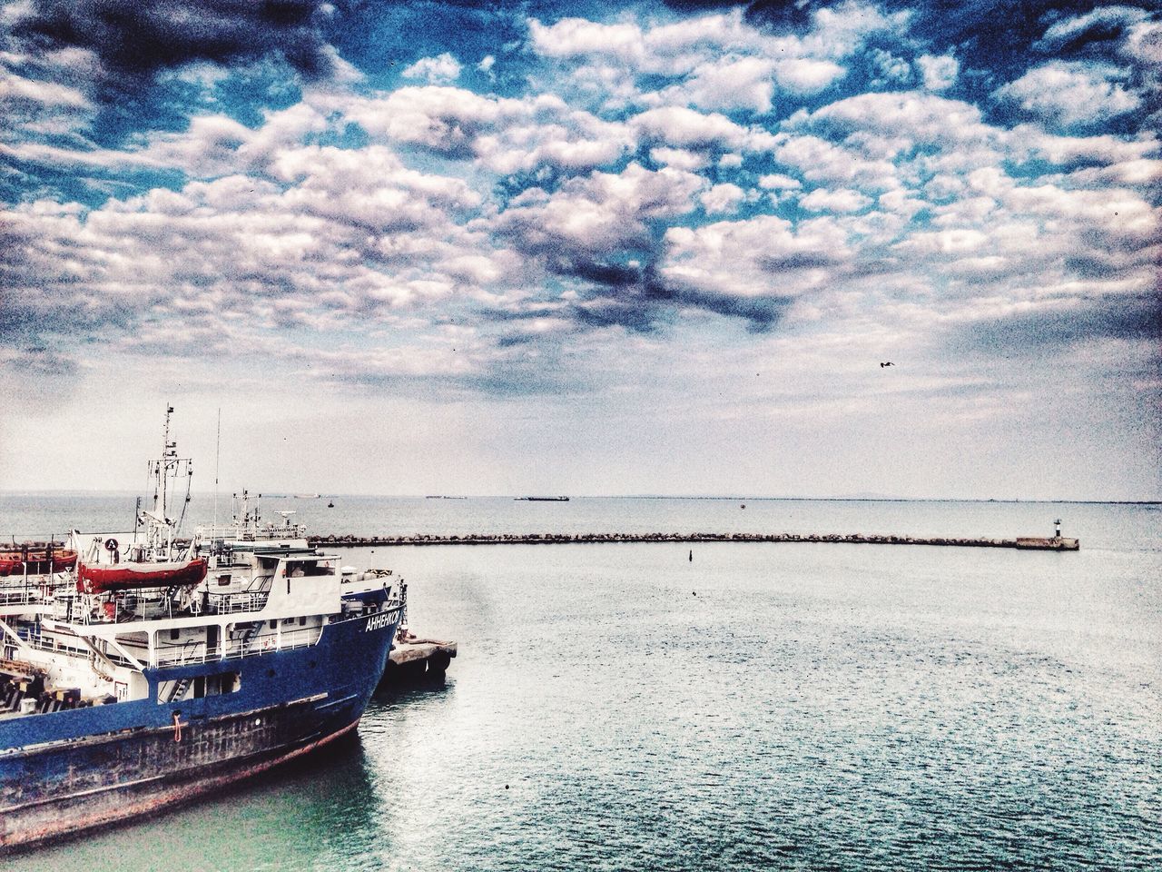 nautical vessel, transportation, sea, water, mode of transport, boat, waterfront, scenics, cloud, seascape, ocean, calm, sky, tranquility, nature, tranquil scene, beauty in nature, day, outdoors, cloudscape, cloud - sky, majestic, cloudy, no people, non-urban scene, journey, clouds