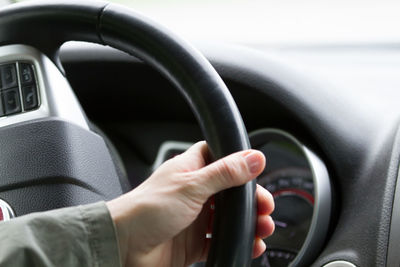 Cropped image of man driving car