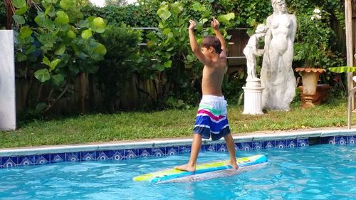 Full length of shirtless boy in swimming pool