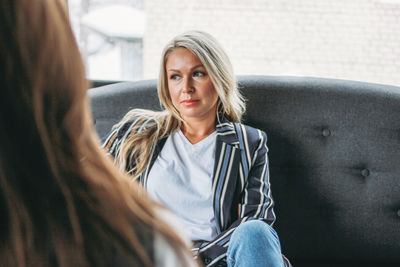 Woman sitting on sofa