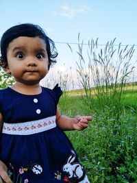 Portrait of cute boy standing on field