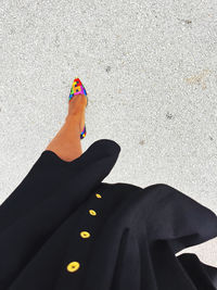 Stepping out to church  in my multicolored heels, as my black dress rises with the breeze. 