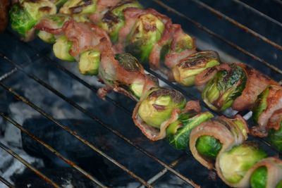Close-up of bacon wrapped vegetables on barbecue grill