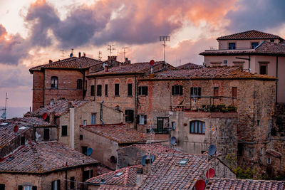 Buildings in city against cloudy sky