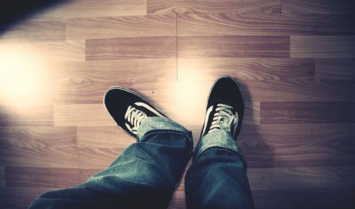 Low section of woman standing on tiled floor