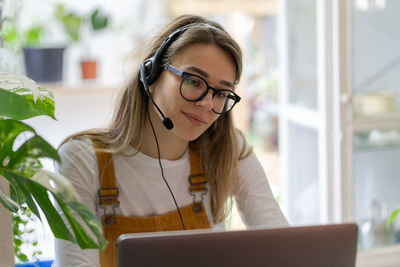 Smiling woman talking on video call at shop