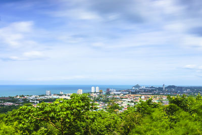 Scenic view of sea and cityscape against sky