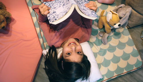 High angle view of woman sitting on sofa at home