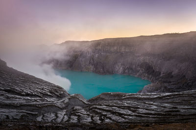 Smoke emitting from volcanic mountain against sky