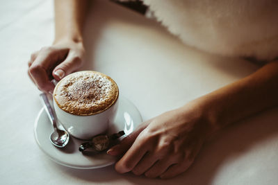 Hand holding coffee cup