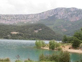 Scenic view of lake and mountains against sky