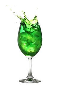 Close-up of drink in glass against white background